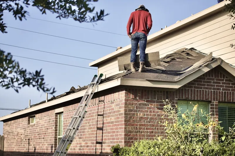 Professional roofer working on a residential roof in Rock Harbor
